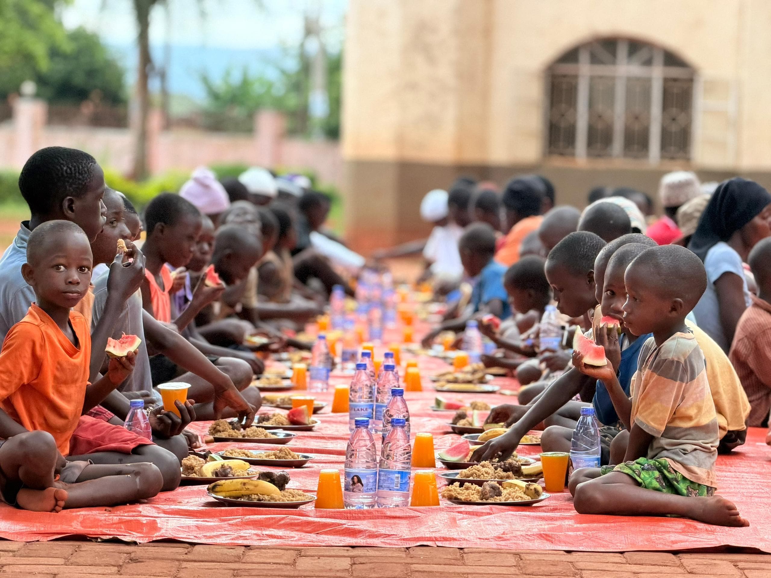 Children from Musana's feeding programme sharing a meal together in Eastern Uganda
